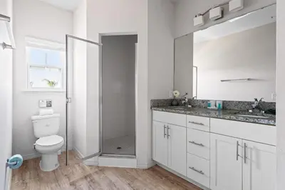 a white bathroom with a toilet and a shower at 4BR Community pool across the street WL8989 in Kissimmee
