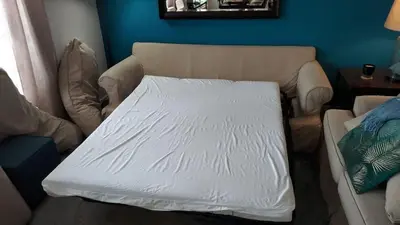a living room with a couch with a white mattress at 4BR Community pool across the street WL8989 in Kissimmee