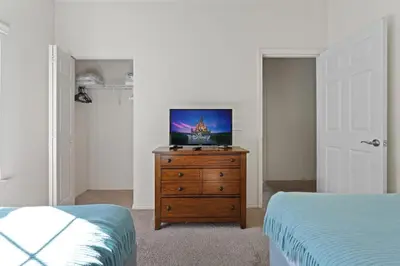 a bedroom with a dresser with a television on it at Cozy Decor 4BR at West Lucaya Resort WL8972 in Kissimmee