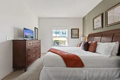 a bedroom with a large bed with a television on a dresser at Cozy Decor 4BR at West Lucaya Resort WL8972 in Kissimmee