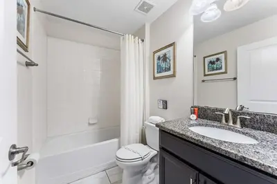 a white bathroom with a sink and a toilet at 5BR Themed Bedrooms at Storey Lake SL4702 in Kissimmee