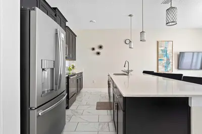 a kitchen with a stainless steel refrigerator at Cute with Private Pool at Storey Lake SL4802 in Kissimmee