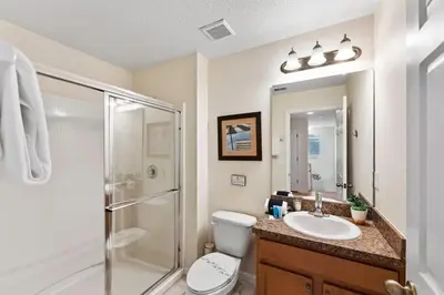 a bathroom with a shower and a toilet and a sink at 4BR Townhome with Lake View – BL481 in Kissimmee