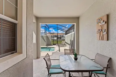 a dining room with a table and chairs and a patio at Family Friendly Home 4BR Private Pool SL4823 in Kissimmee