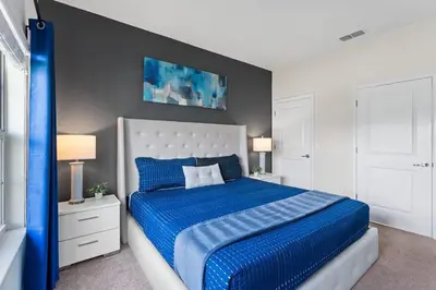a bedroom with a blue bed with two night stands at Family Friendly Home 4BR Private Pool SL4823 in Kissimmee