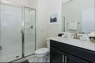 a bathroom with a shower and a toilet and a sink at Family Friendly Home 4BR Private Pool SL4823 in Kissimmee