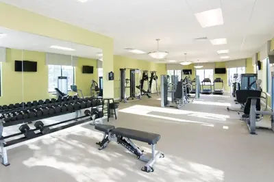 a gym with treadmills and machines in a room at Family Friendly Home 4BR Private Pool SL4823 in Kissimmee