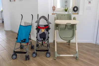two strollers sitting next to a desk and a table at 4 BR No carpet Just Remodeled Unit SR1205 in Kissimmee