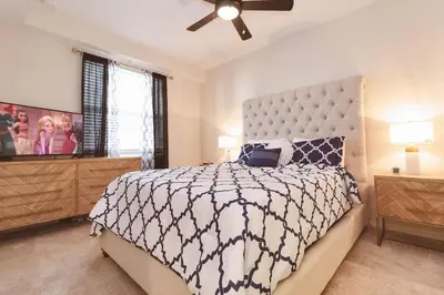 a bedroom with a large bed and a ceiling fan at 2 BR Modern Apt near Disney SL4741 in Kissimmee