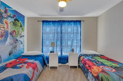 a bedroom with two beds and a large window at Disney Themed House Free Heated Pool close Disney 5br 9bd in Orlando
