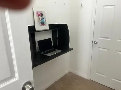 a black shelf with a laptop on a wall at Disney Themed House Free Heated Pool close Disney 5br 9bd in Orlando