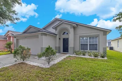 a house with a green lawn at Disney Themed House Free Heated Pool close Disney 5br 9bd in Orlando