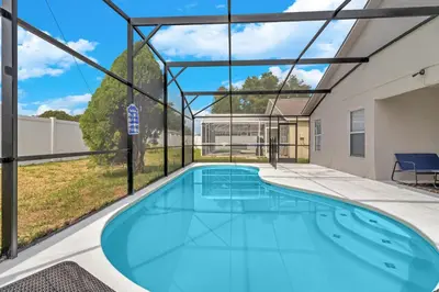 a large swimming pool in a building with a large window at Disney Themed House Free Heated Pool close Disney 5br 9bd in Orlando
