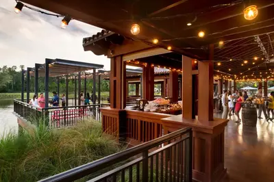 a food court with people walking around in a park at Four Seasons Resort Orlando at Walt Disney World Resort in Orlando