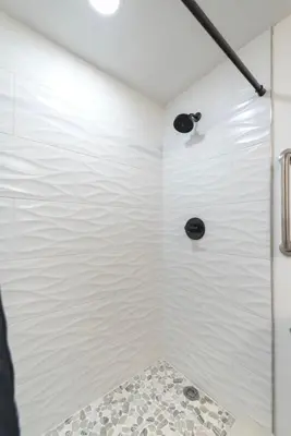 a bathroom with a shower with white walls at Studio near Universal Studios with great view in Orlando