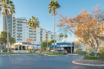 a parking lot in front of a building with palm trees at Studio near Universal Studios with great view in Orlando