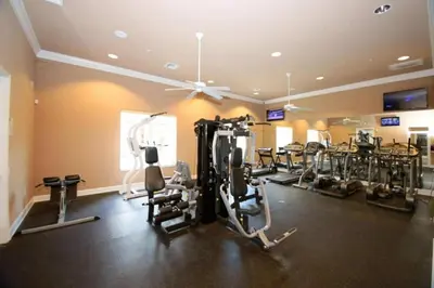 a gym with several treadmills and cardio machines at 4572 Perfect home for your family close to all parks in Kissimmee