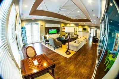 a living room with a couch and a table at 5372 Lovely home inside Disney area in Kissimmee