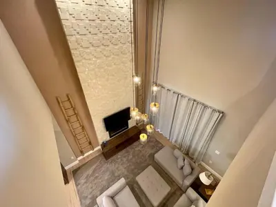 an overhead view of a living room with a couch and a tv at Home in Orlando 7 Min from Disney Parks and 20 from Universal - Sleeps 8! 4 bedrooms each with a private bathroom in Orlando
