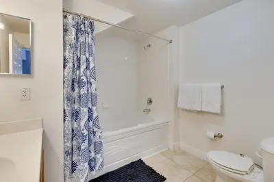 a bathroom with a shower and a toilet at 12 Mi to Disney Family Home with Resort Amenities! in Kissimmee