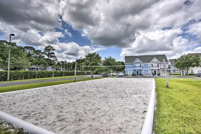 an empty volleyball court in front of a house at 12 Mi to Disney Family Home with Resort Amenities! in Kissimmee