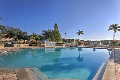 a large swimming pool with blue water at 12 Mi to Disney Family Home with Resort Amenities! in Kissimmee