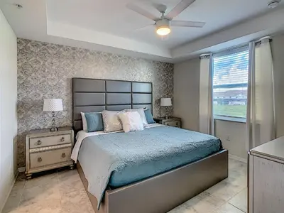 a bedroom with a large bed and a window at Luxury Brand NEW 2 bedroom apt near DISNEY! in Kissimmee