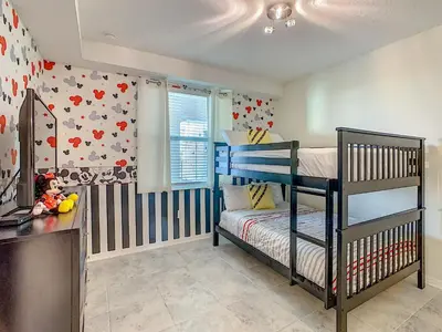 a bedroom with a bunk bed and a desk at Luxury Brand NEW 2 bedroom apt near DISNEY! in Kissimmee