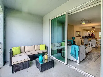 a living room with a couch and a table at Luxury Brand NEW 2 bedroom apt near DISNEY! in Kissimmee