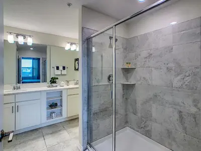 a bathroom with a shower and a sink at Luxury Brand NEW 2 bedroom apt near DISNEY! in Kissimmee