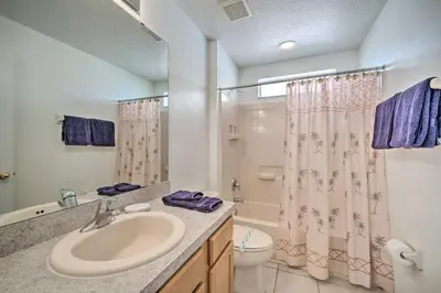 a bathroom with a sink and a toilet and a shower at Pool and Lanai Emerald Isle Resort Home! in Kissimmee