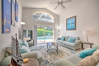 a living room with two couches and a table at Pool and Lanai Emerald Isle Resort Home! in Kissimmee