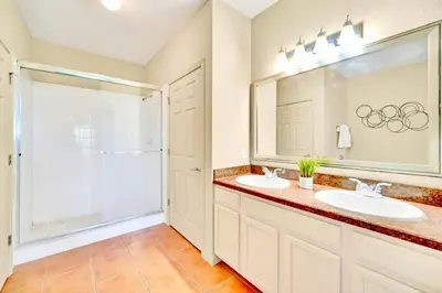 a bathroom with two sinks and a shower at Near Disney - Spacious 3BR Condo with Pool in Orlando