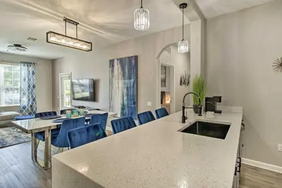 a kitchen and living room with a sink and a table at Vista Cay Resort Condo about 5 Mi to Universal! in Orlando