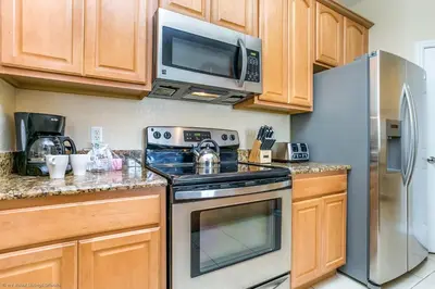 a kitchen with a stove and a microwave at 4814 Cayview Avenue #401 in Orlando
