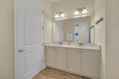 a white bathroom with a sink and a mirror at 2914 Salted Rim Road in Orlando