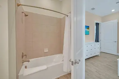 a white bathroom with a tub and a sink at 2914 Salted Rim Road in Orlando