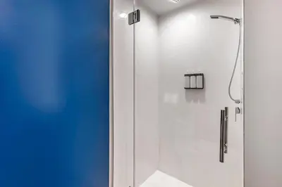 a shower with a glass door in a bathroom at Cambria Hotel Orlando near Universal Theme Parks in Orlando