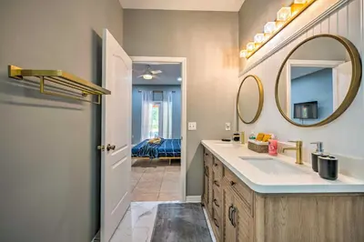 a bathroom with a sink and a mirror at Sunny Clermont Retreat with Lanai 12 Mi to Disney! in Orlando