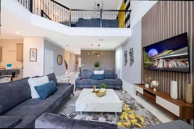 a living room with a couch and a tv at Stunning Family Friendly 5 Bd w/ Pool Close to Disney @ Storey Lake 4242 in Kissimmee