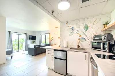 a kitchen with a sink and a microwave at Lovely Studio near Universal in Orlando