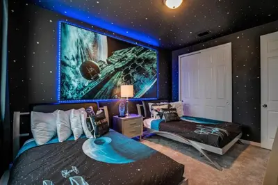 a bedroom with two beds and a wall with stars at Darth's Manor 9 Bed 6 Bath Huge Home Solara Resort villa in Orlando