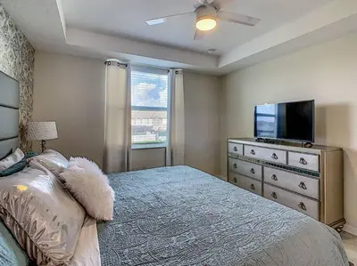 a bedroom with a bed and a flat screen tv at Last minute deal! Brand New 2bed apt near Disney in Kissimmee
