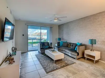 a living room with a couch and a table at Last minute deal! Brand New 2bed apt near Disney in Kissimmee