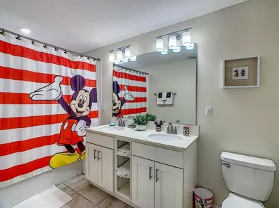 a bathroom with a american flag shower curtain and a sink at Last minute deal! Brand New 2bed apt near Disney in Kissimmee