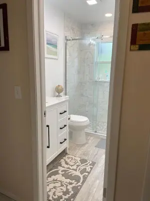 a bathroom with a toilet and a glass shower at Sanford Lake Mary Quiet Rooms in Sanford