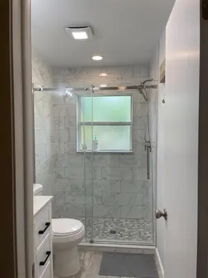 a bathroom with a shower with a toilet and a window at Sanford Lake Mary Quiet Rooms in Sanford