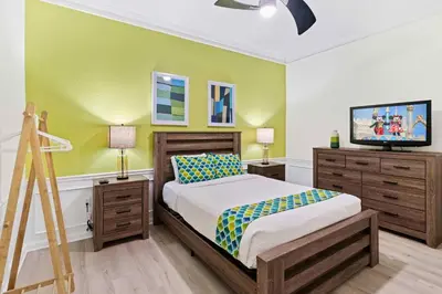 a bedroom with a bed and a flat screen tv at Vista Cay at Epic Universe - Luxury 4 bedroom penthouse in Orlando