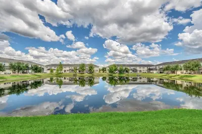 a view of a pond at a campus at 4 Bed townhome with Private Pool Near Disney! townhouse in Kissimmee