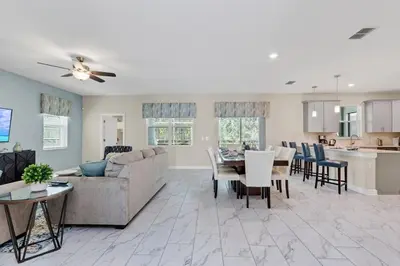 a living room with a couch and a table at Monopoly Fun Storey Lake Resort 6 Bed Star Home! villa in Kissimmee